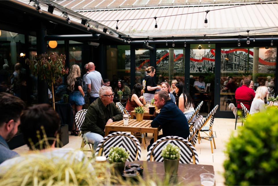 Outdoor cafe with people enjoying drinks