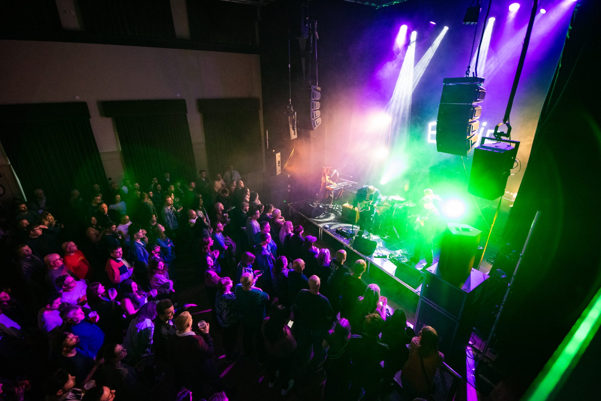 Crowd at a vibrant indoor concert event